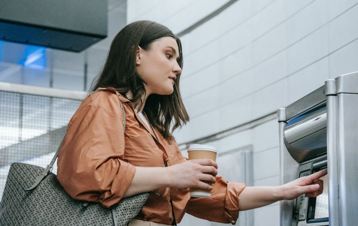 Una mujer hace una transferencia en un cajero / PEXELS