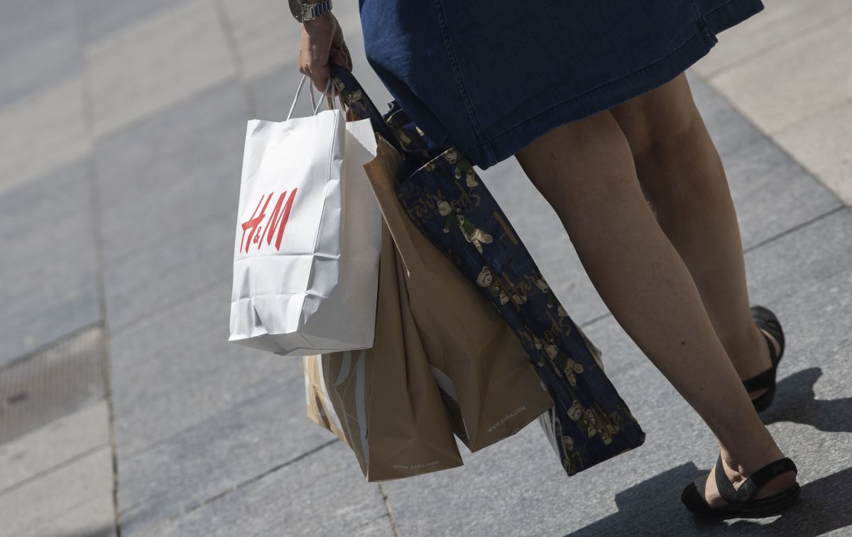 Una mujer pasea cargada con varias bolsas tras comprar en tiendas de ropa / EP
