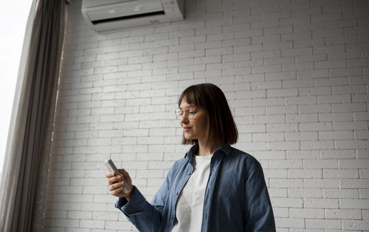 Una mujer se plantea si poner el aire acondicionado debido al alto precio de la luz / FREEPIK