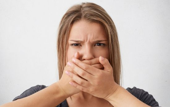 Una mujer preocupada por su mal aliento / WAYHOMESTUDIO - FREEPIK Una mujer preocupada por su mal aliento / WAYHOMESTUDIO - FREEPIK