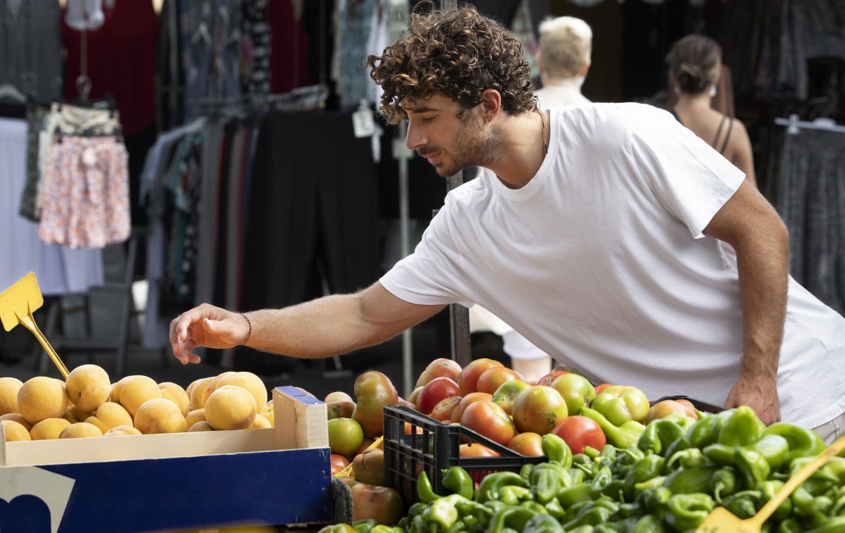 Un joven compra frutas y patatas, algunos de los alimentos que más se encarecen / FREEPIK