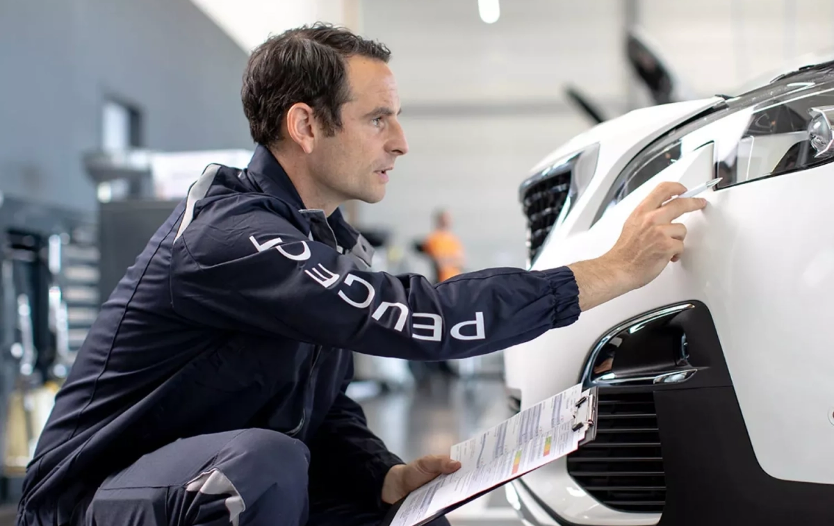 Un mecánico de Peugeot pasa la revisión de un coche en un taller oficial de la casa / PEUGEOT