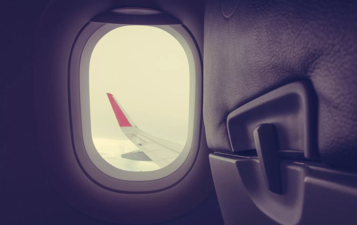 La ventana de un avión con las persianas subida / FREEPIK