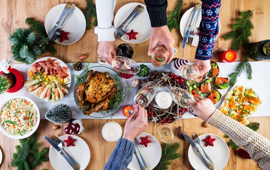 Varias personas alrededor de una mesa en Navidad / FREEPIK - @timolina Varias personas alrededor de una mesa en Navidad / FREEPIK - @timolina