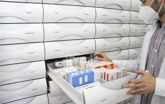 Un farmacéutico abre una estantería con medicamentos / LUDA Un farmacéutico abre una estantería con medicamentos / LUDA