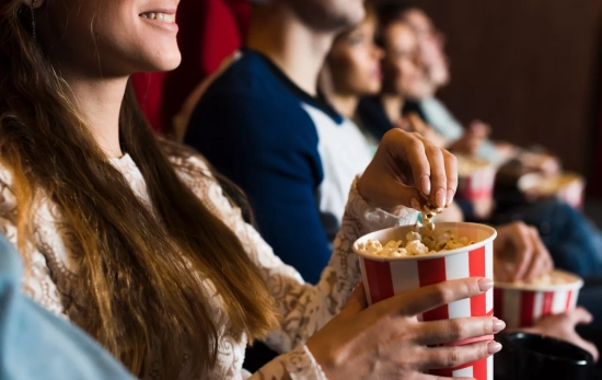 Varios asistentes disfrutan de una película en un cine / FREEPIK Varios asistentes disfrutan de una película en un cine / FREEPIK