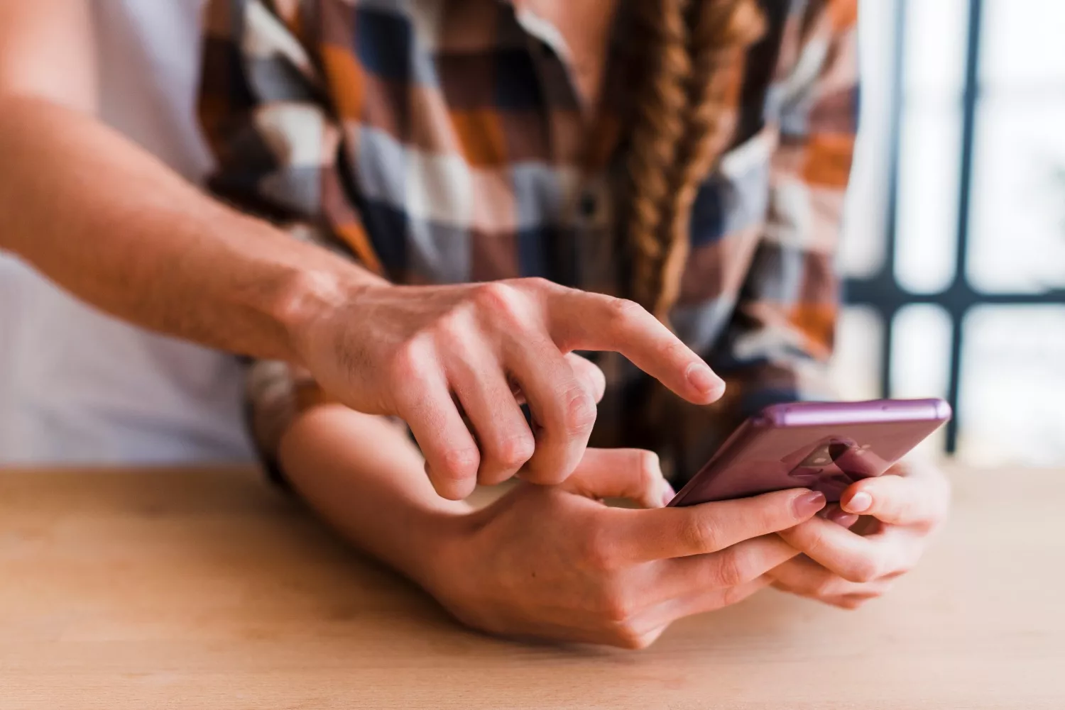 crop couple using smartphone together (1)