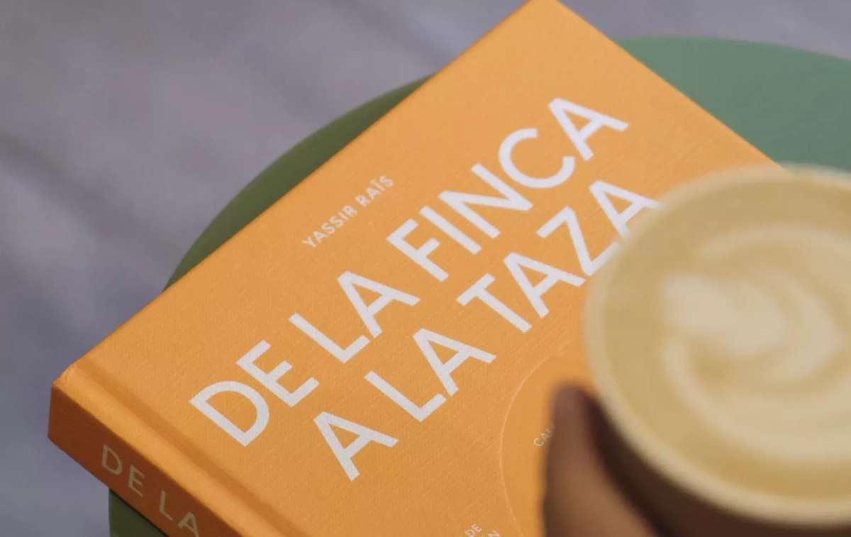 El nuevo libro de Yassir Raïs, 'De la finca a la taza', junto a un café / SYRA COFFEE El nuevo libro de Yassir Raïs, 'De la finca a la taza', junto a un café / SYRA COFFEE