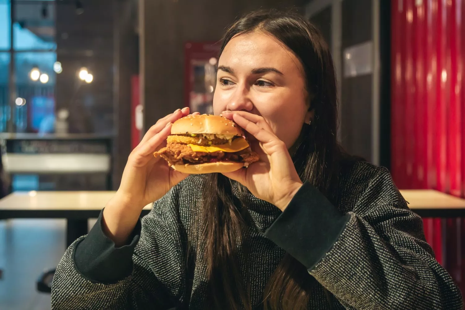 Una persona se come una hamburguesa de cachopo / FREEPIK - pvproductions