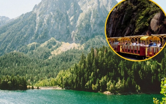 El Tren de Artouste surca un imponente lago de aguas verdes y cristalinas/ Montaje CG El Tren de Artouste surca un imponente lago de aguas verdes y cristalinas/ Montaje CG