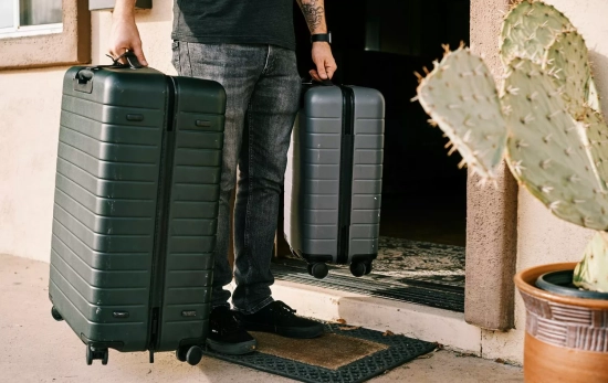 Una persona porta dos maletas / UNSPLASH Una persona porta dos maletas / UNSPLASH