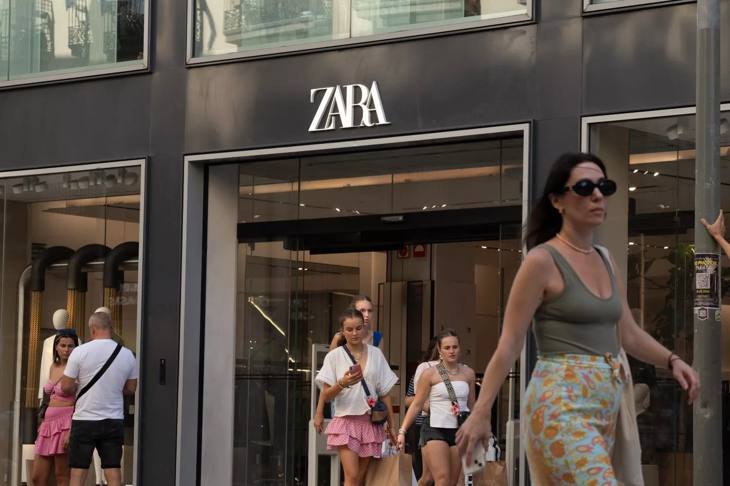 Varias personas pasan delante de una tienda Zara (Inditex), en el centro de Barcelona / EUROPA PRESS - DAVID ZORRAKINO