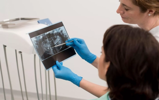 Una profesional muestra a un paciente una radiografía de sus dientes / FREEPIK Una profesional muestra a un paciente una radiografía de sus dientes / FREEPIK