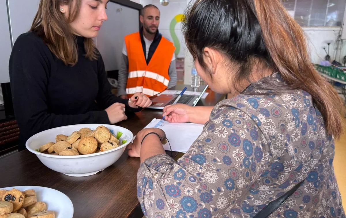 Una madre firma su asistencia para recoger la cesta asignada ANA CARRASCO Una madre firma su asistencia para recoger la cesta asignada ANA CARRASCO