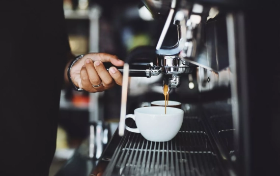 Una persona prepara un café con una cafetera tipo De'Longhi La Specialista Touch/ PEXELS