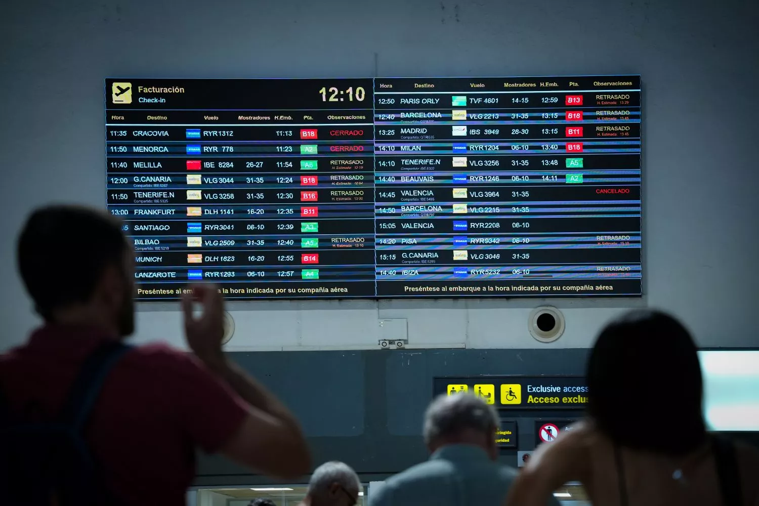 Pasajeros con su billete de avión consultan la información de su vuelo / María José López - EP