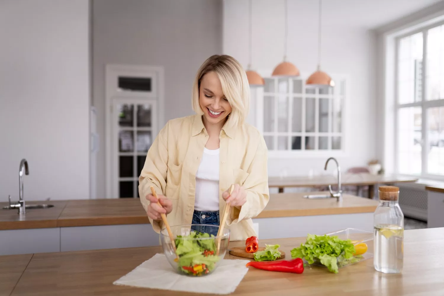 Una mujer prepara una ensalada con alimentos saludables similares a los de Aldi / FREEPIK