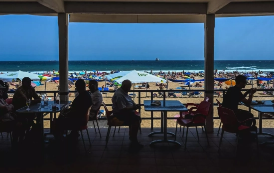 Turistas en la terraza de un restaurante en la Primera playa de El Sardinero Turistas en la terraza de un restaurante en la Primera playa de El Sardinero