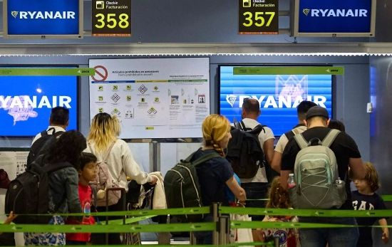 Un grupo de personas en un puesto de facturación de Ryanair en el Aeropuerto Adolfo Suárez Madrid Ba