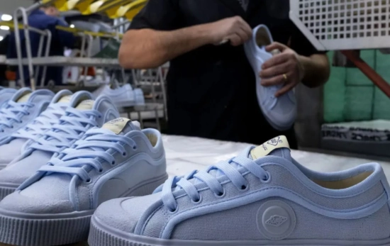 Un trabajador de la marca con varias zapatillas / SANJO Un trabajador de la marca con varias zapatillas / SANJO