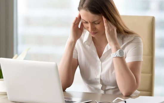 Una mujer padece migrañas por exceso de pantallas/ CANVA Una mujer padece migrañas por exceso de pantallas/ CANVA