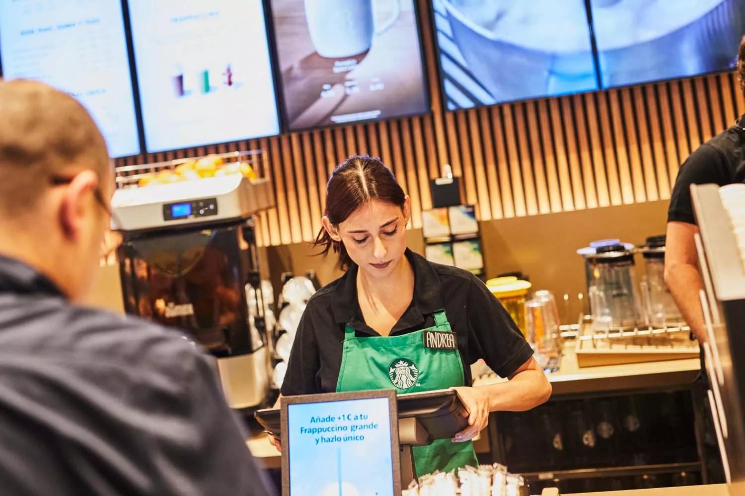 Una empleada de Starbucks toma nota a un cliente   CEDIDA