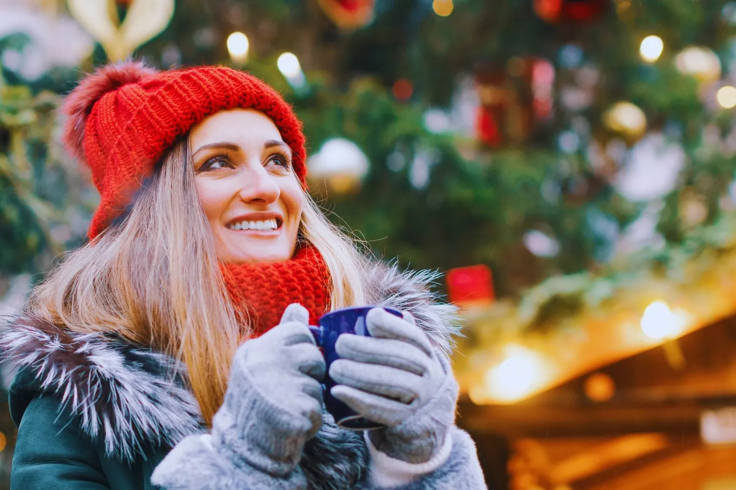 Imagen de archivo de una mujer en un mercadillo de Navidad / CANVA