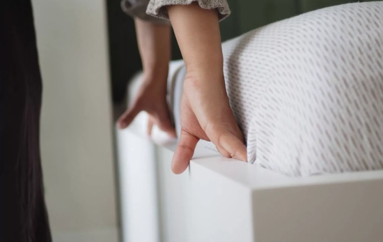 Una persona haciendo la cama/ CANVA