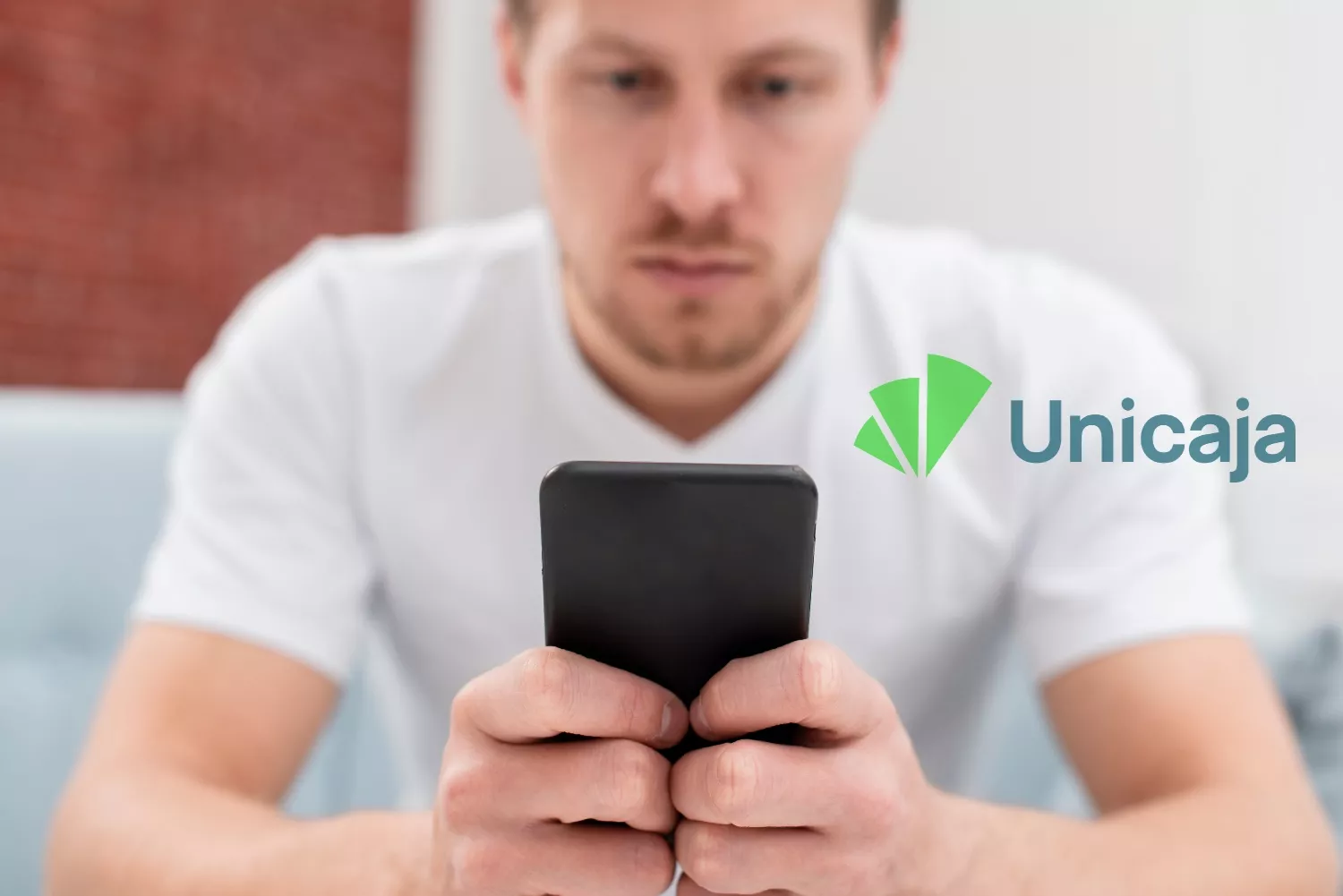 Un cliente de Unicaja mira su móvil