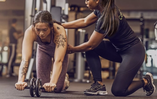 Una sesión de gimnasio con entrenadora personal/ CANVA