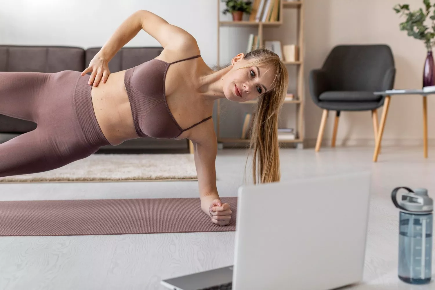 Una mujer entrena en su casa con un conjunto de Oysho / OYSHO